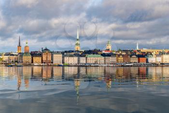Panorama of Gamla Stan in Stockholm, Sweden. The town dates back to 13th Century. The brightly colored city reflected in artificial water