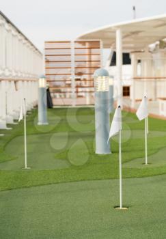 Artificial turf on mini golf or putting green on deck of cruise ship