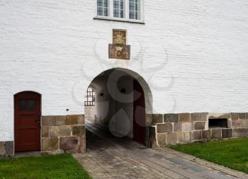 White exterior and entrance to Aalborghus Castle in the old town of Aalborg in Denmark