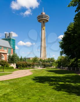 NIAGARA FALLS, CANADA - JUNE 29, 2016: Skylon Tower and observation deck above gardens of Fallsview Casino Resort in Niagara Falls, Ontario, Canada