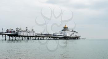 EASTBOURNE, UK - SEPTEMBER 19, 2016: View across the ocean to the pier and theatre at Eastbourne, UK
