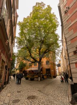 STOCKHOLM, SWEDEN - SEPTEMBER 9: Tourists in Tyska Brunnsplan square in Gamla Stan on September 9, 2017 in Stockholm, Sweden. The square was first mentioned in 1649