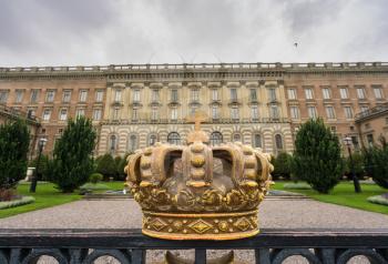 Painted crown on railings around Royal Palace in Gamla Stan, Stockholm, Sweden