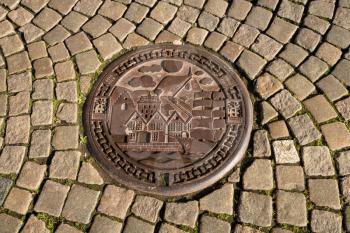BERGEN, NORWAY - 23 SEPTEMBER 2017: Engraved manhole cover showing port of Bergen, City of Culture, in Norway