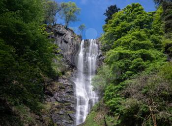 High falling water in waterfall and cascades at head of Pistyll Rhaeadr falls in Wales