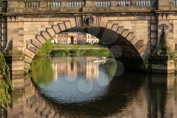 View of river Severn and English Bridge in Shrewsbury Shropshire with Eight rowing boat in background