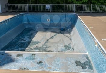Empty in ground swimming pool ready for replacement of old vinyl lining or liner