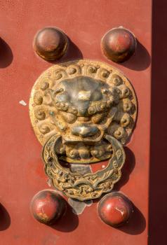 Detail of lion head door knocker at Temple of Heaven in Beijing, China