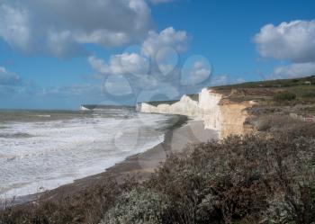 Panorama of rocky beach on stormy day looking towards Seven Sisters at Birling Gap near Eastbourne