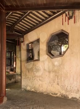 Entrance into small courtyard with tree planting in Yu or Yuyuan Garden in  the old city of Shanghai