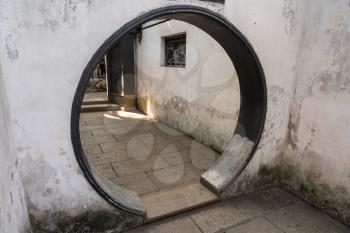 Round doorway into small courtyard in Yu or Yuyuan Garden in  the old city of Shanghai
