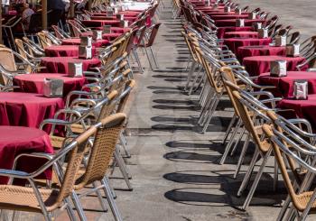 Empty tables and chairs of outdoor cafe in Plaza Mayor in Salamanca