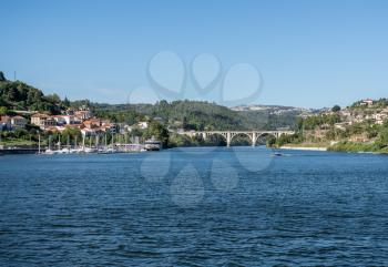 Small marina with power boats and docked river cruise boat in the Douro valley near Porto
