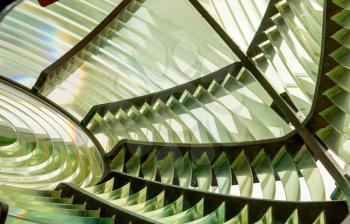 Close image of the glass prisms making up a fresnel lens in a lighthouse