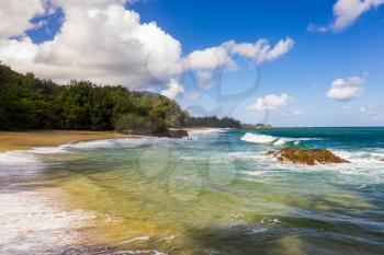 Aerial panoramic image off the coast over Lumaha'i beach on Hawaiian island of Kauai with Na Pali mountains behind