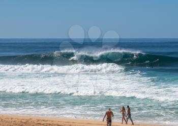 Surfer inside a big wave in the sea at Banzai Pipeline on north coast of Oahu, Hawaii