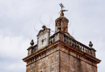 Detail of the clock and windvane on the the Se or cathedral church tower in the old town of Viseu