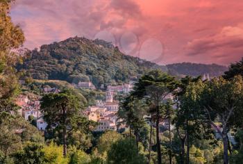 Sunset view of the Portuguese town of Sintra with the Moorish fortress on the hilltop above the city
