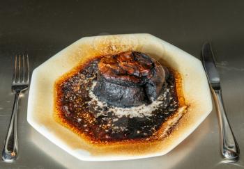 Pastry meat pie completely charred and burned after leaving in the microwave oven too long