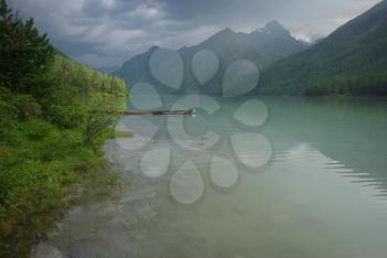 Beautiful mountain landscape near the lake. Mountain Lake. Kind of mountainous terrain and the water in the valley.