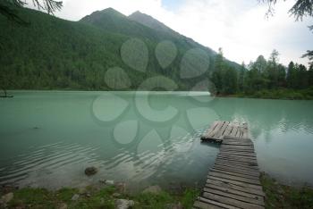 Beautiful mountain landscape near the lake. Mountain Lake. Kind of mountainous terrain and the water in the valley.