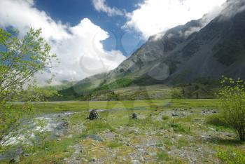 Mountain landscape. Highlands, the mountain peaks, gorges and valleys. The stones on the slopes.