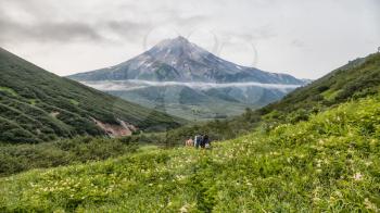 Mountains and volcanoes. Beautiful landscape of Kamchatka Peninsula: summer panoramic view of Mountain Range Vachkazhets, mountain lake and clouds in blue sky on sunny day. Eurasia, Russian Far East, 
