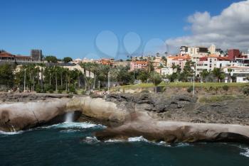 Costa Adeje, Tenerife, Spain - July 28, 2013: The islands of Tenerife is a resort for tourists. Coast of the sea and hotels on the beach.