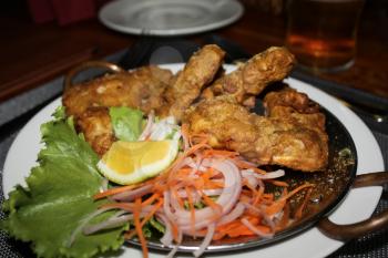 Fish battered with salad. Restaurant dish in the kitchen. The food cooked at restaurant. Various dishes for every taste and choice.
