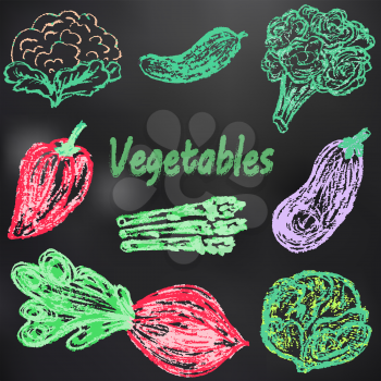 Child drawing with chalk on a black board. Tasty vegetables. Useful pictures. Cauliflower, cucumber, broccoli, bell pepper, eggplant, white cabbage, beetroot