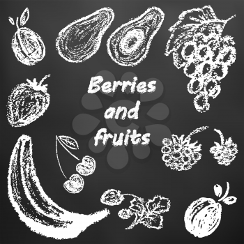 Children's drawing of white chalk on a black board. Bright beautiful fruits. Tasty and healthy. Plum, avocado, grapes, raspberries, strawberries, cherries, strawberries, banana, apricots