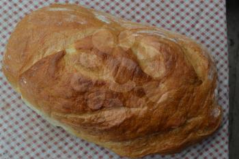 Bread. A loaf of bread. Freshly baked bread. Food. Tablecloth. Delicious. Close-up. Horizontal photo