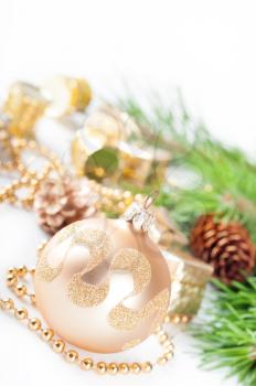 Golden Christmas decorations and green pine branch