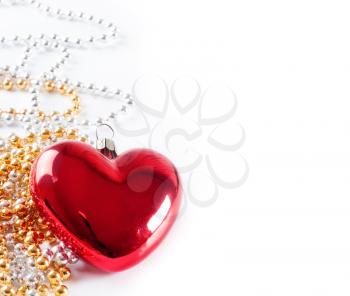 Christmas background with red heart and golden beads