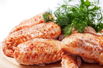Spicy raw chicken wings  with green dill 