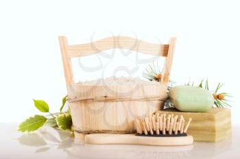Aromatic bath salt in wooden bucket and handmade soap
