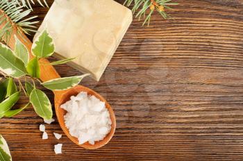 Aromatic bath salt in a wooden spoon and bar of soap