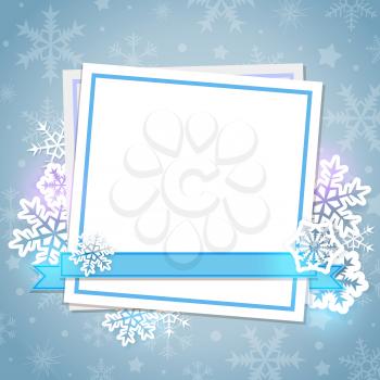 White paper card and snowflakes on a blue background. Christmas background.