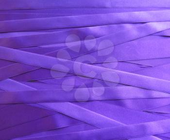 purple satin ribbons in a messy mess texture background