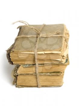 a stack of shabby old books tied with string on white background