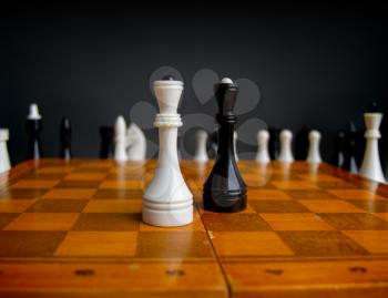 old chess on a chess classic wooden board on a dark background