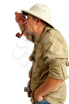 traveler in a cork helmet and khaki clothes smoking a pipe and looking at something