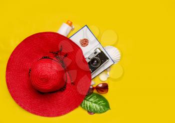 top view set of women's beach accessories and things for relaxation on a bright yellow background