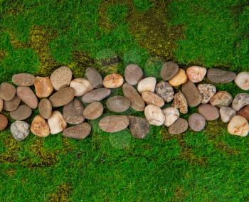 narrow path made of stones among green grass top view. Artificial Grass Used