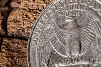 quarter american dollar coin closeup on old wooden surface