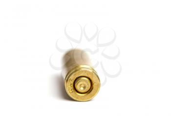 one used shot brass cartridge case from a nine millimeter pistol on a white background close-up