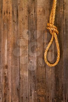 coarse thick rope nautical knot on dark wooden background with empty place for text