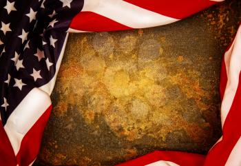 United states of america flag wrapped around a rusty metal plate to form a starry striped frame