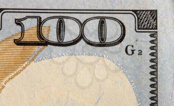 close up image of 100 denomination on a hundred dollar bill of the United States of America