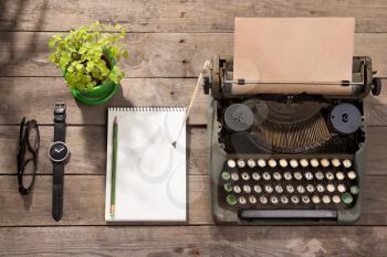 Vintage typewriter on the old wooden desk